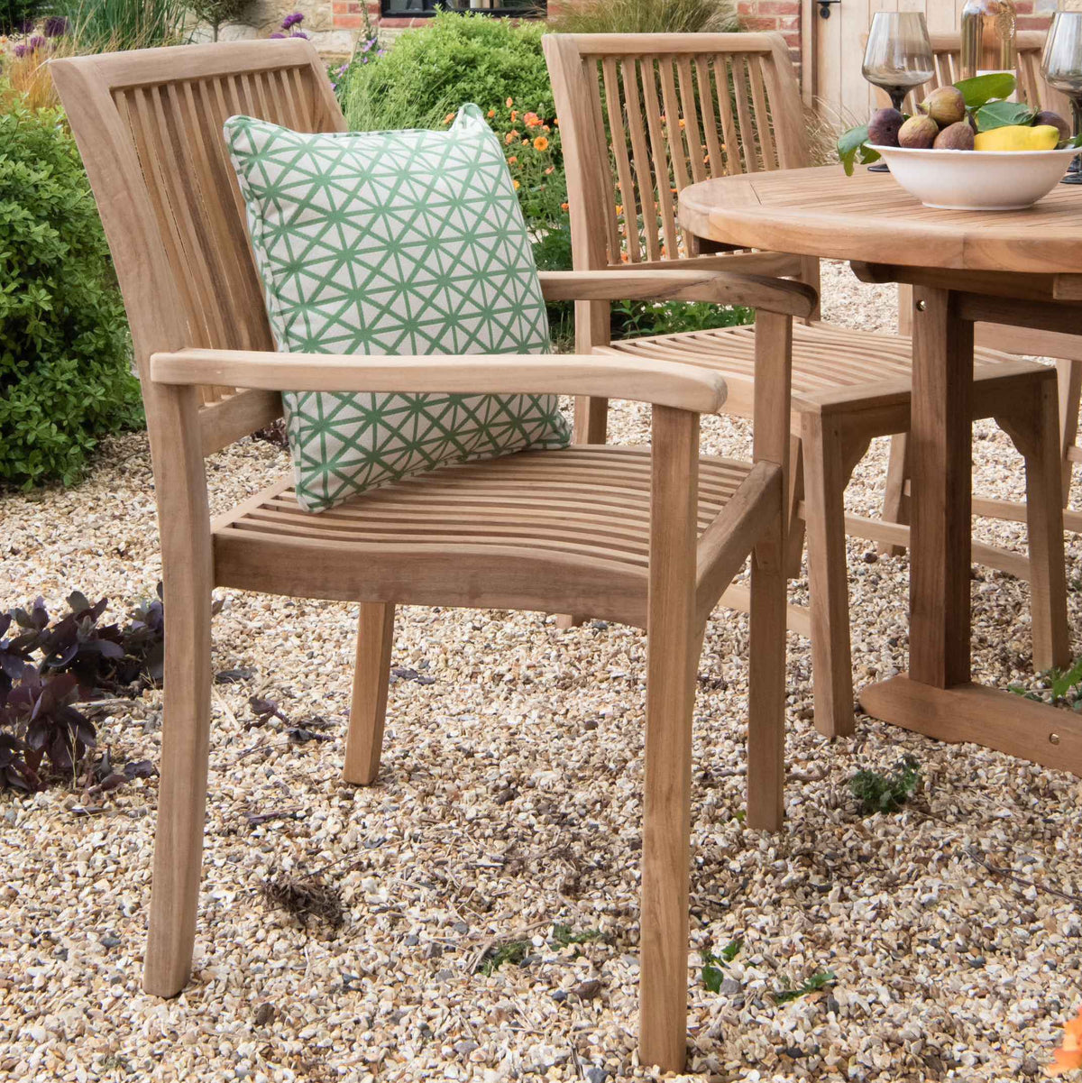 Teak Armchair with green scatter cushion