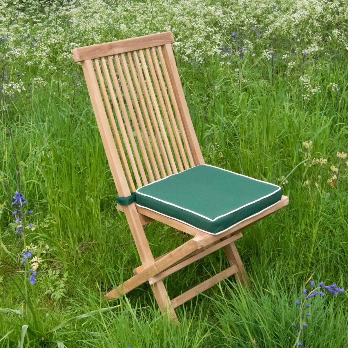 Folding teak chair with green cushion