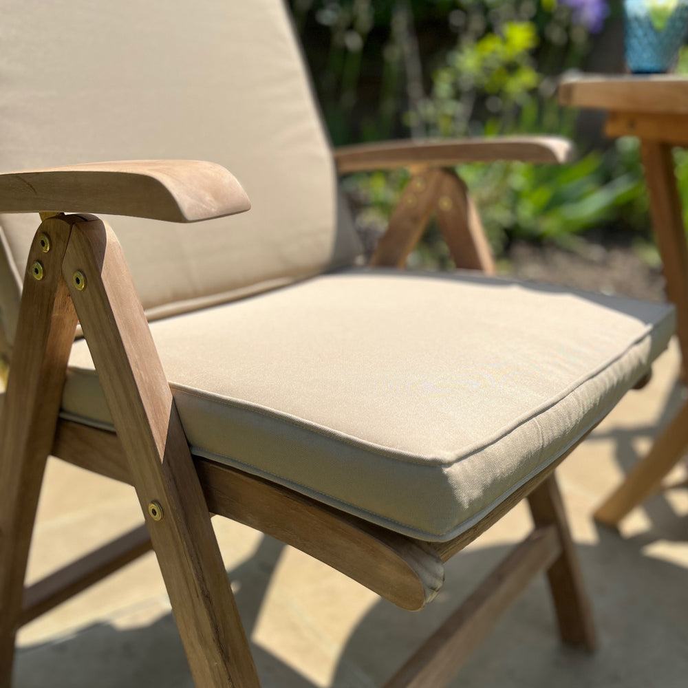 
                  
                    Teakunique's redesigned Borneo recliner with cream cushion close up
                  
                