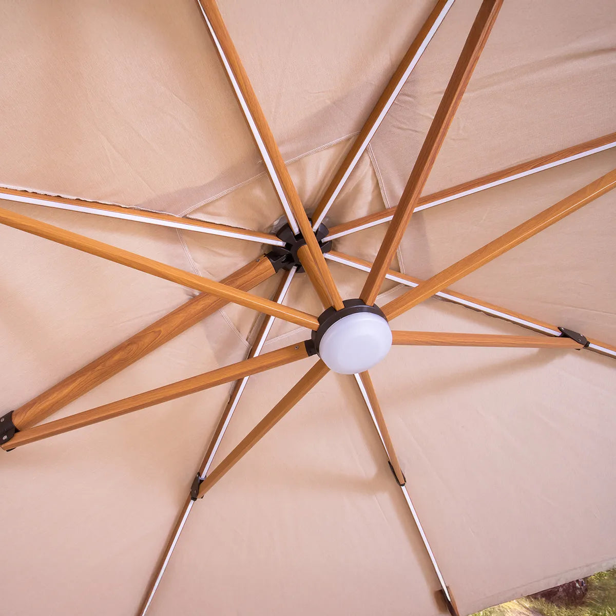 Close-up of a beige patio umbrella with wooden ribs.