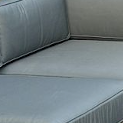 
                  
                    Close up of grey cushions  on teak outdoor sofa
                  
                
