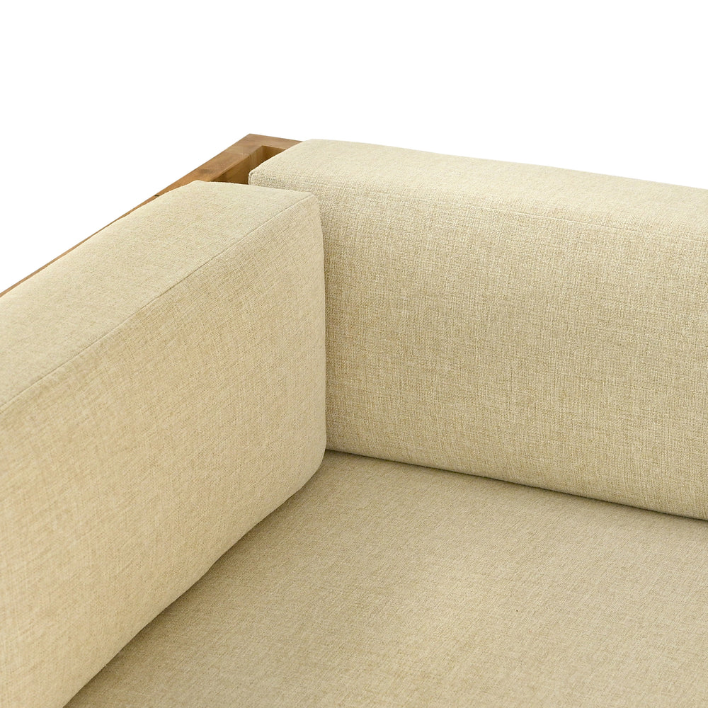 
                  
                    Close up of corner of teak outdoor sofa with cream cushions, with a focus on the fabric texture.
                  
                