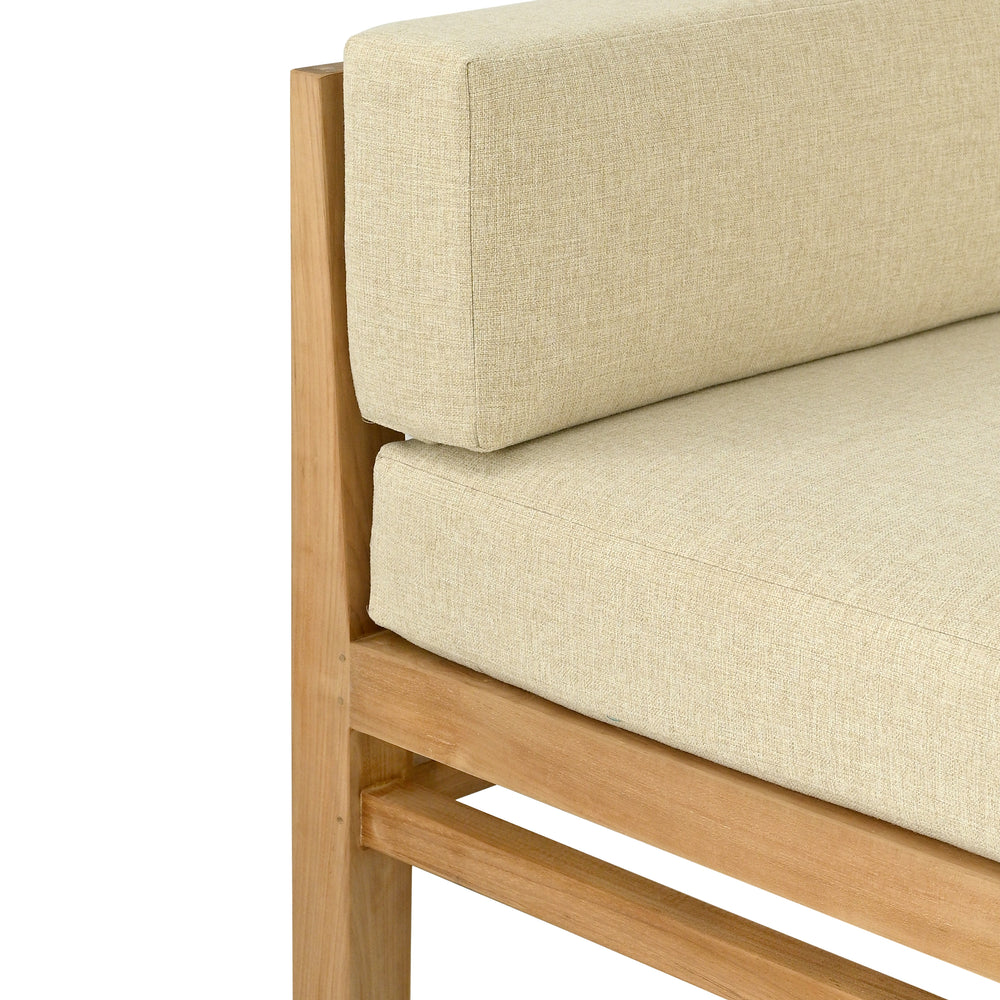 
                  
                    Close up of one arm and leg of teak outdoor sofa with cream coloured cushions, focus on fabric texture
                  
                