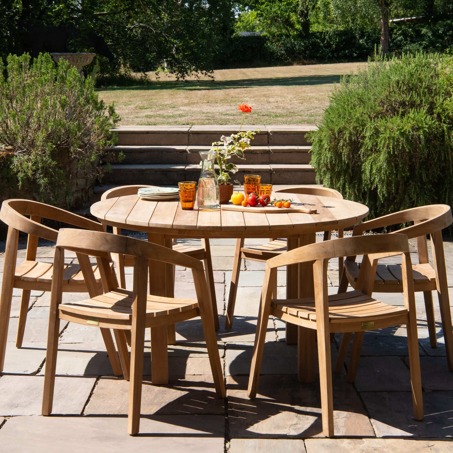 Teak wooden outdoor dining set with table and chairs on a patio