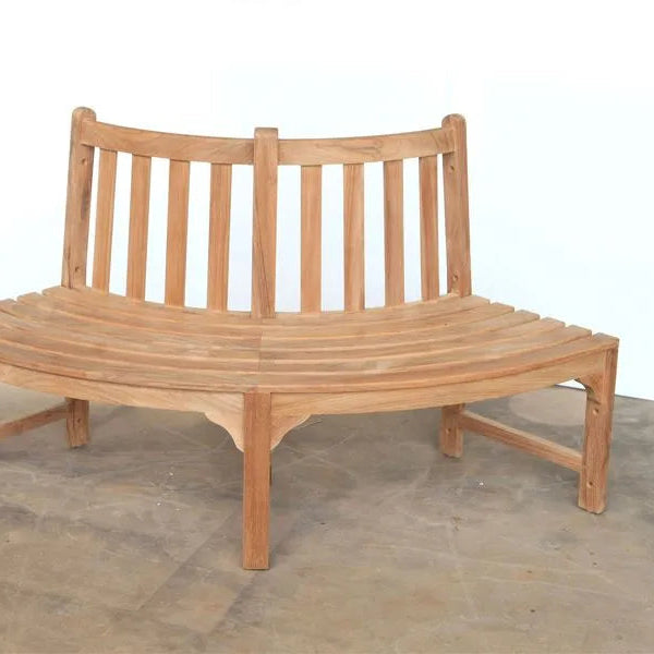 Teak Wooden bench with curved design on a concrete floor