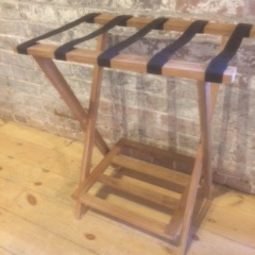 Teak luggage rack with teak wood frame and shelf and canvas straps to hold bags. The rack is unfolded to display its size and capacity