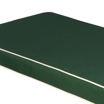 Close up shot of rectangular green bench  cushion with white piping, on a white background 