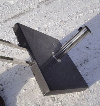 A polished black granite effect 40kg parasol base with a retractable smooth sliding handle and side wheels.