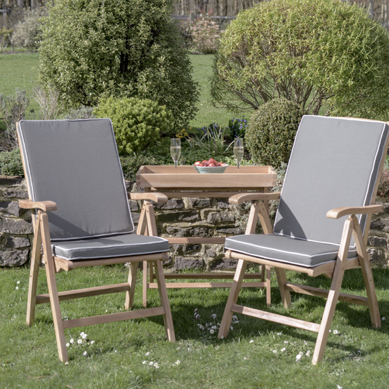 Teakunique's Borneo recliners with grey cushions on the lawn with a Butler's Tray