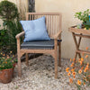 Teakunique's Teak Bali Carver Chair with scatter cushion in an outdoor setting